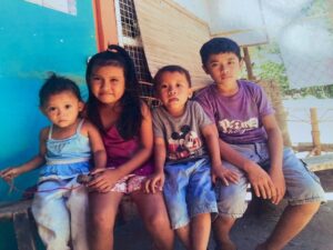 Four children sitting next to each other in the Philippines 