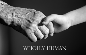 Wholly Human young person and older person holding hands black background